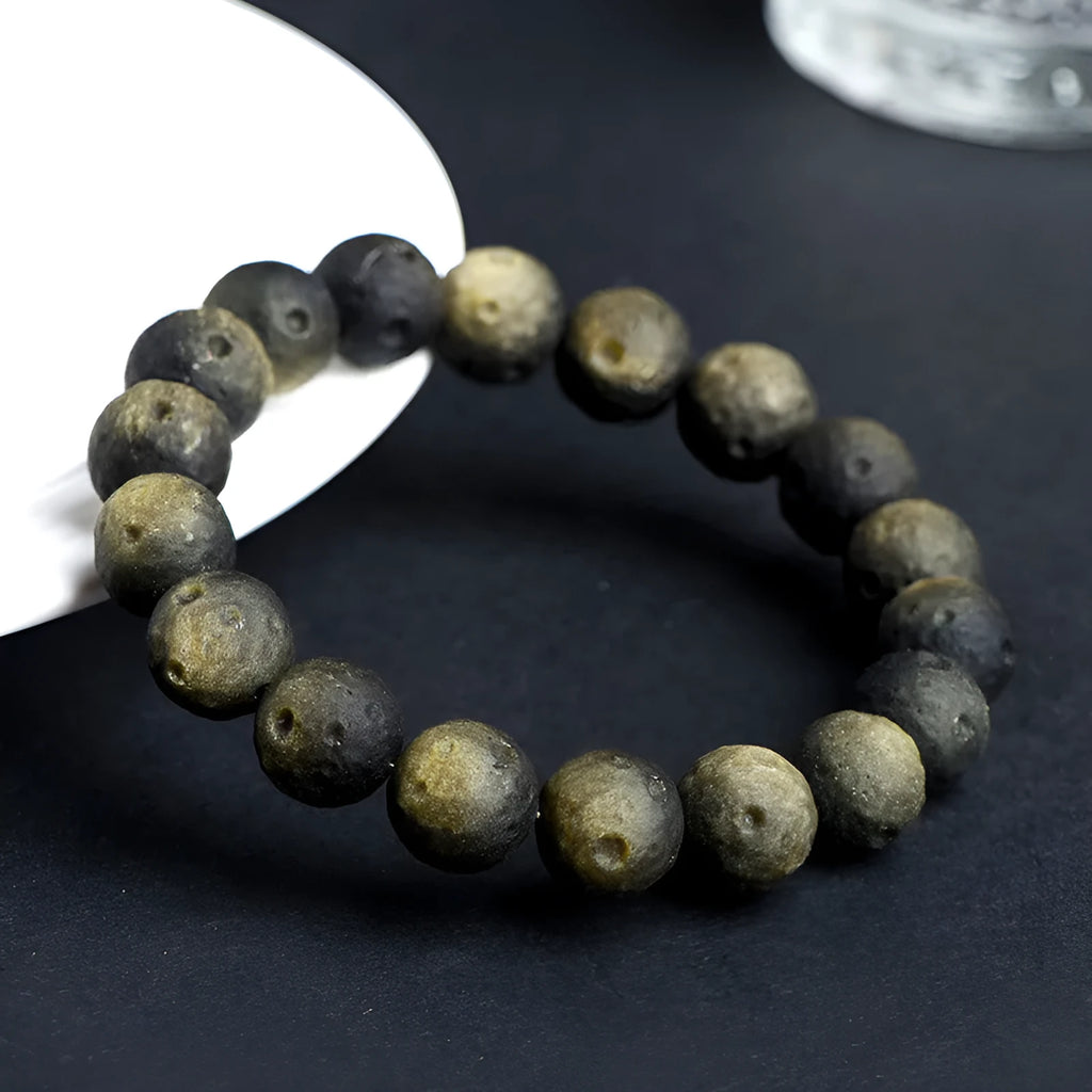 Obsidian meteorite crater ball bracelet with polished stones on adjustable string