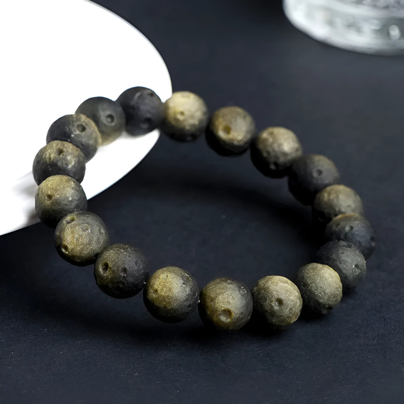 Obsidian meteorite crater ball bracelet with polished stones on adjustable string