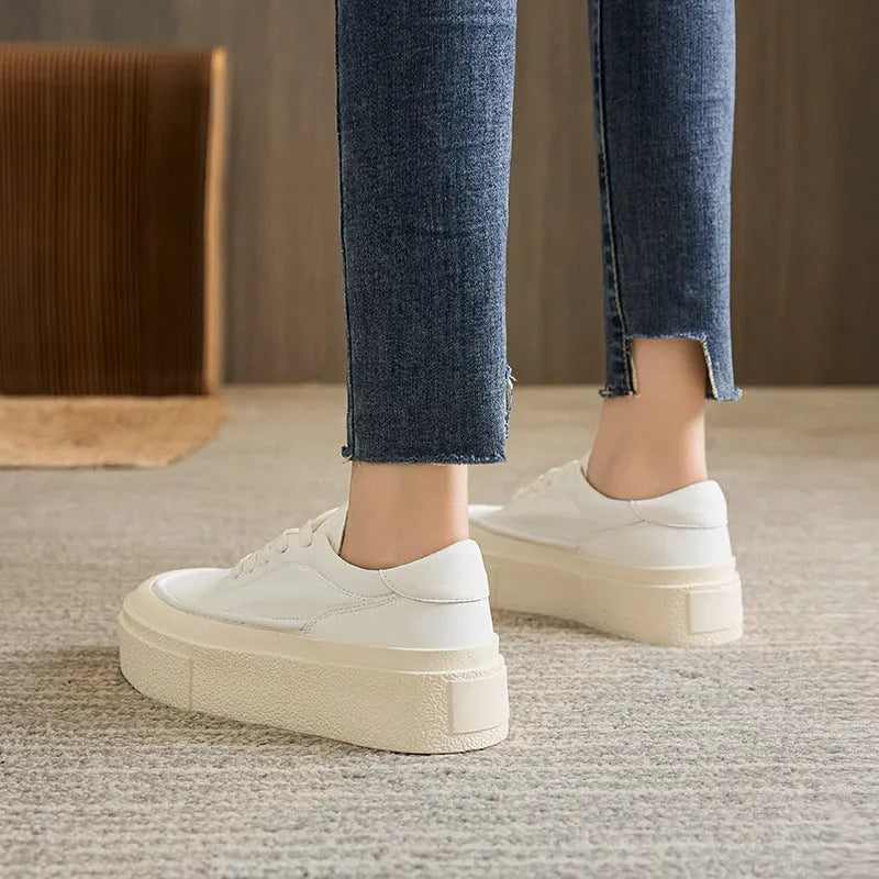 Women's black embossed leather platform sports shoes with round toe and white rubber sole on a white background.