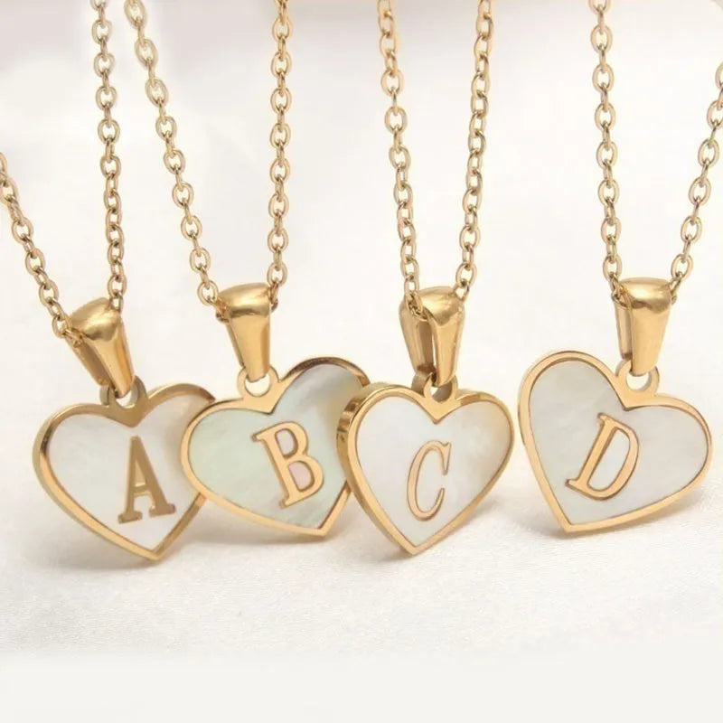 Gold-plated heart necklace with white shell centre on an adjustable stainless steel chain.