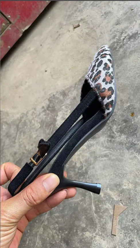 Women's leopard print suede sandals with a pointed toe on a white background.