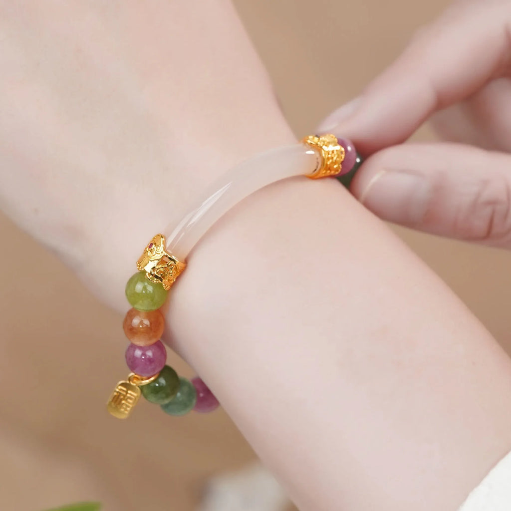 Rainbow tourmaline half-bracelet for women with natural jade colours and electroplated metal setting.