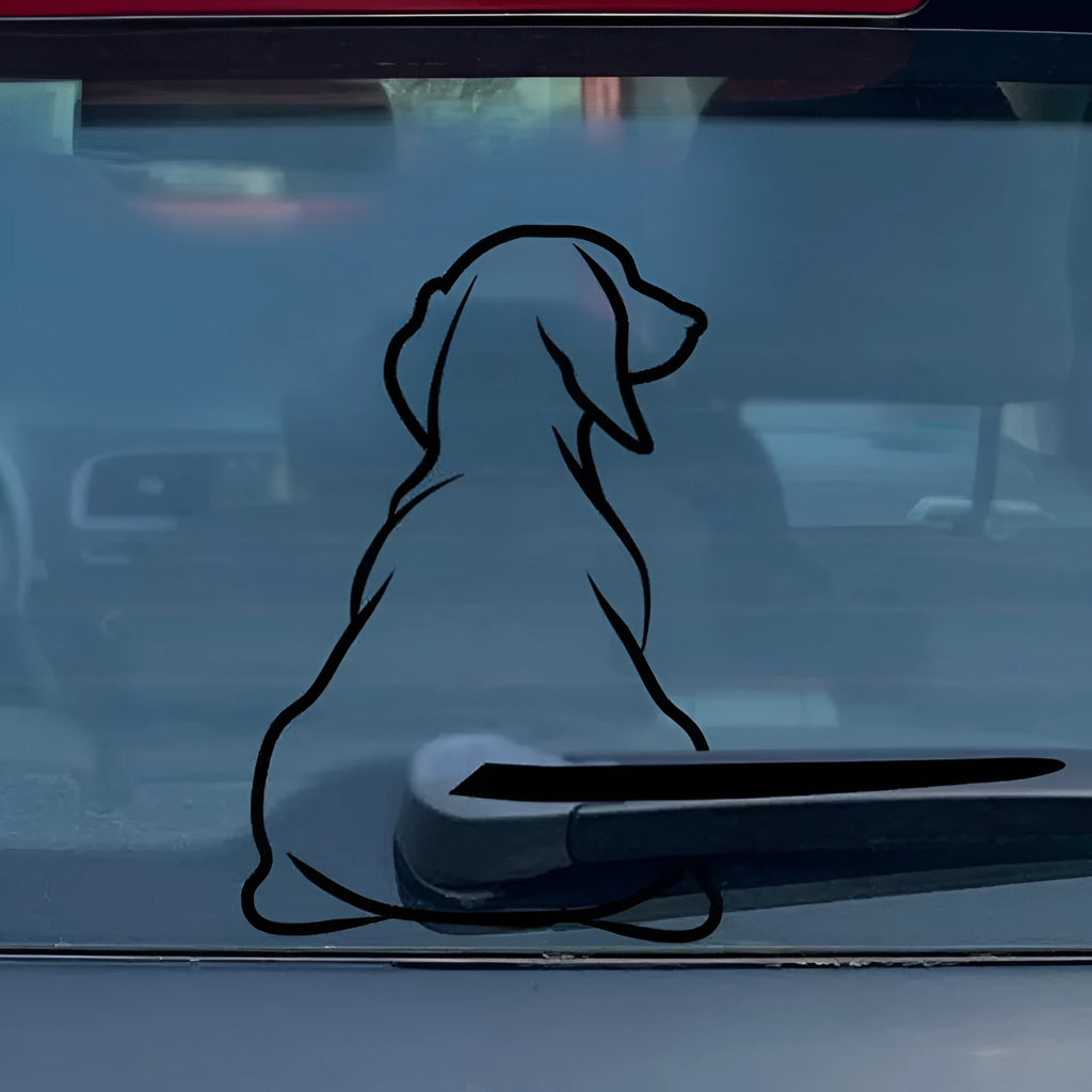 Cartoon dog car window sticker with rear wiper design and wagging tail on vehicle glass