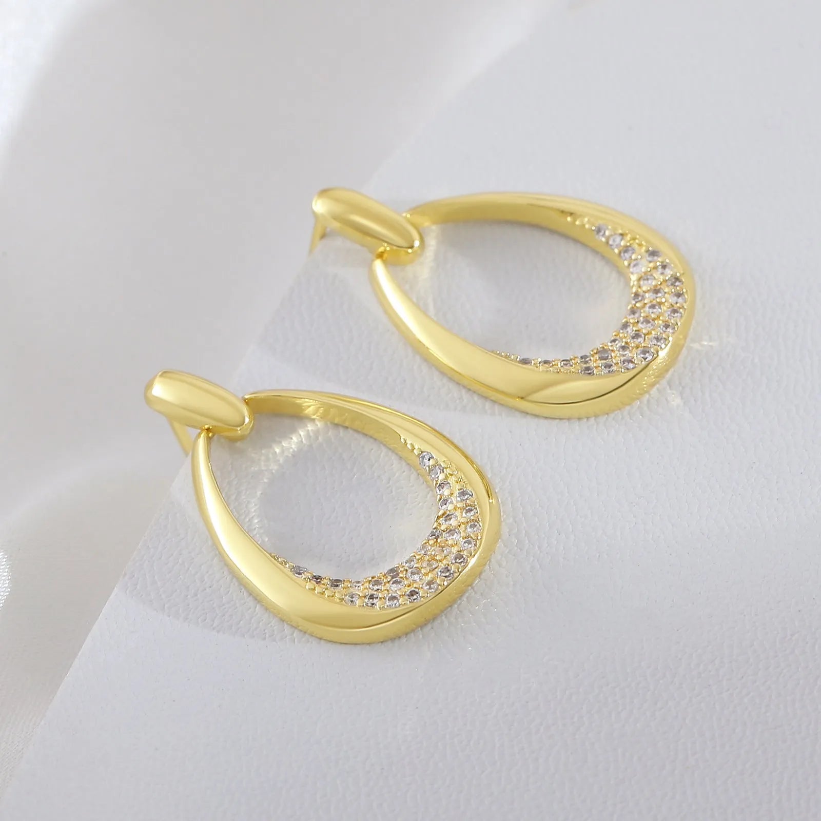 Geometric drop-shaped women's earrings in yellow gold colour with zircon design elements