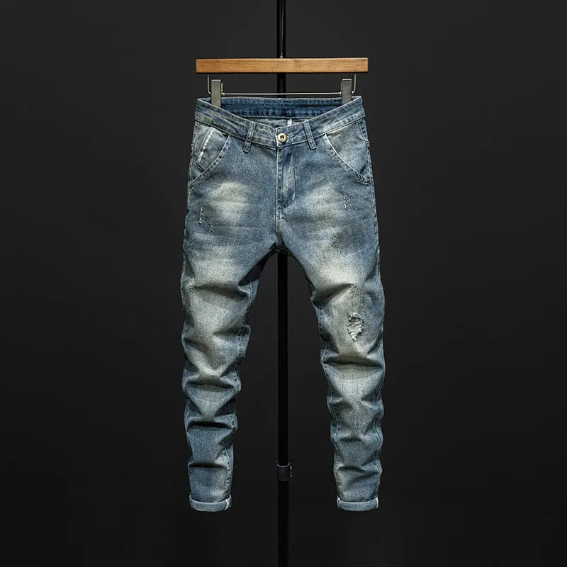 Men's slim-fit skinny jeans in dark blue denim fabric with a mid-rise waist