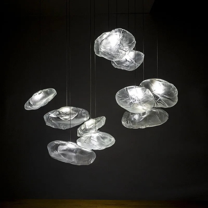 Modern fabric chandelier light with glass shade in amber, clear, or smoke grey, shown in small and large sizes.