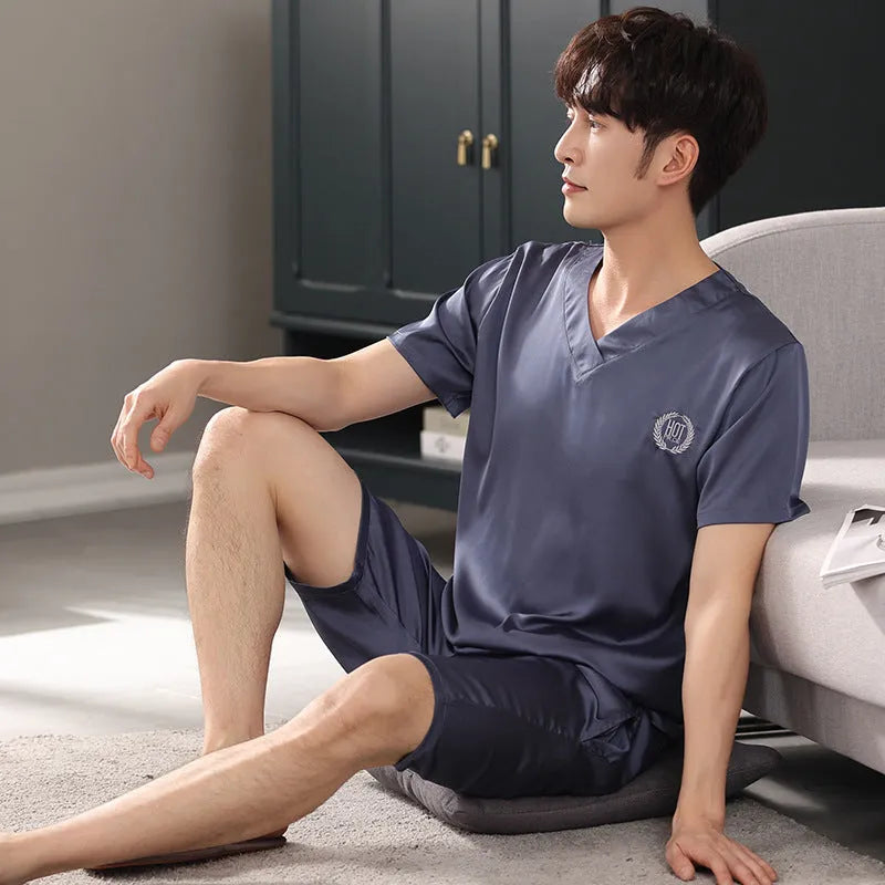 Man wearing a loose light blue short-sleeved Ice silk pajama shirt and matching shorts.