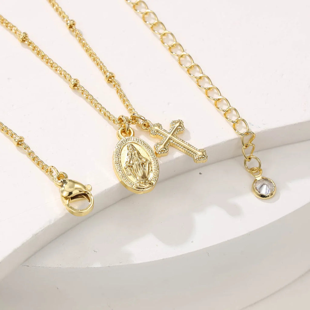 Virgin Mary geometric cross necklace in gold colour with simple styling
