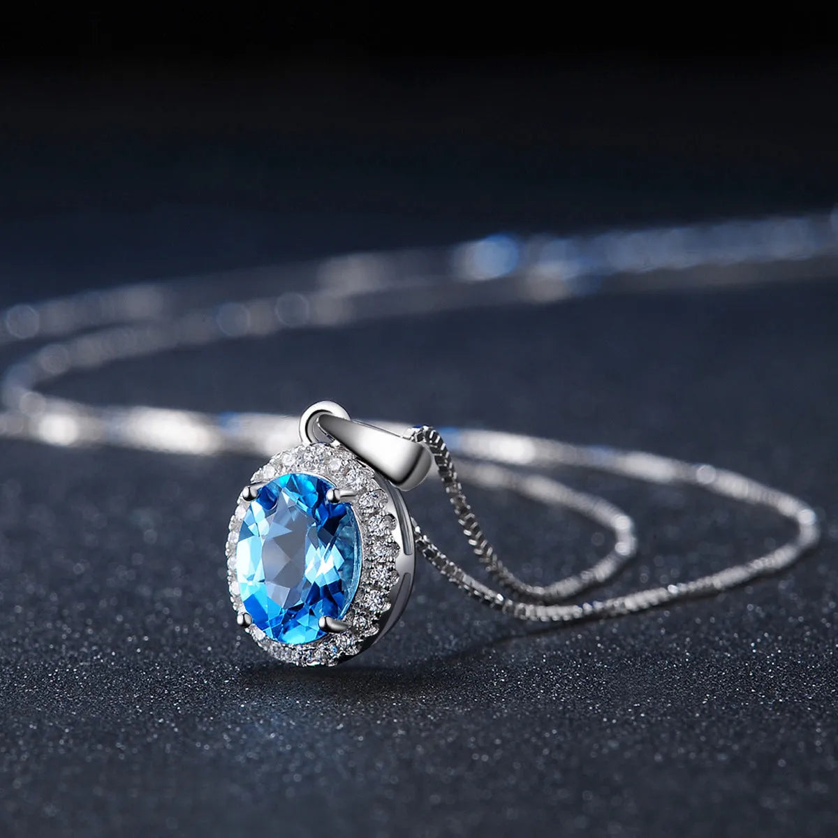 Geometric 925 sterling silver jewellery set with blue topaz stones, showing earrings, ring, pendant and necklace.