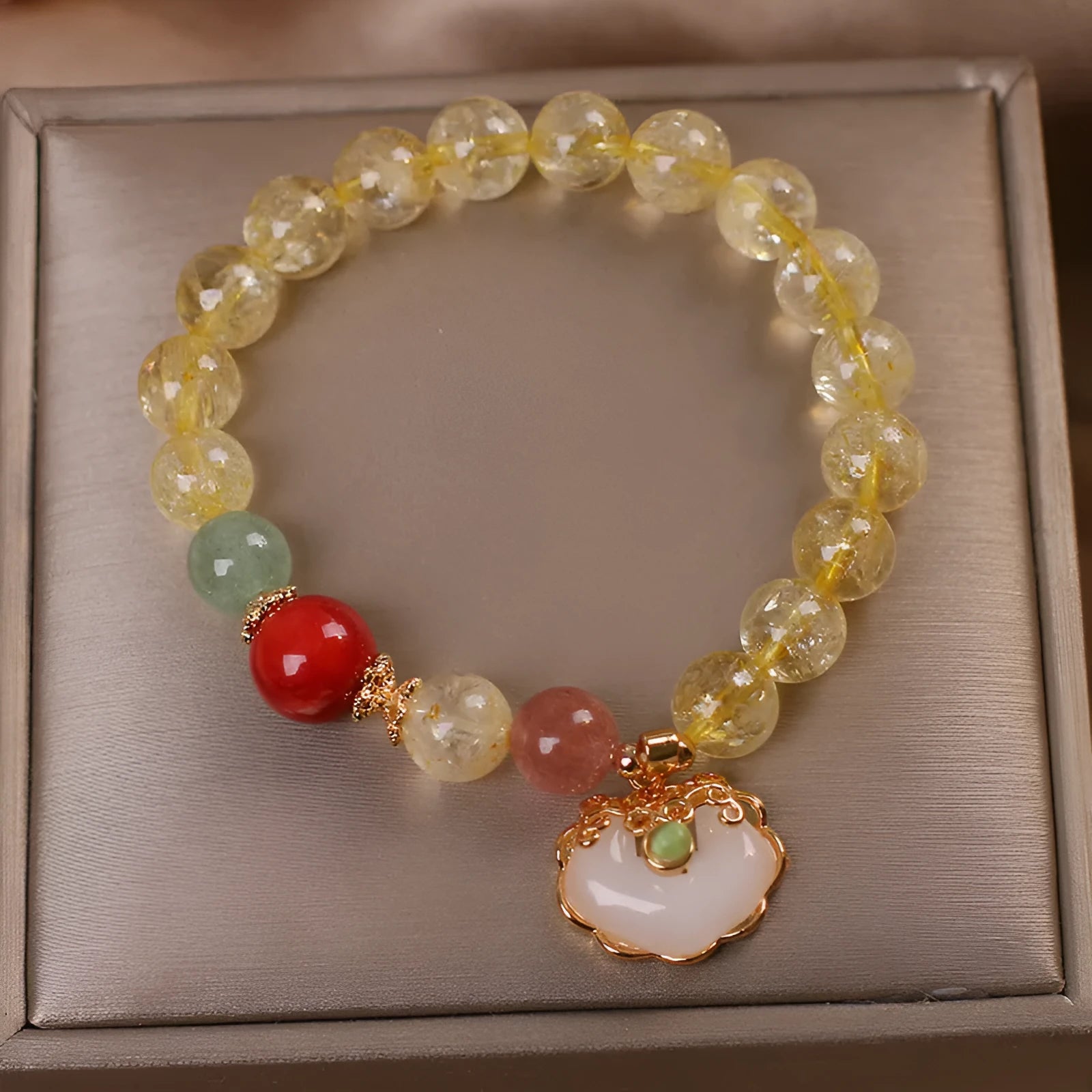 Women's bracelet with a yellow citrine jade ruyi pendant on an alloy chain.