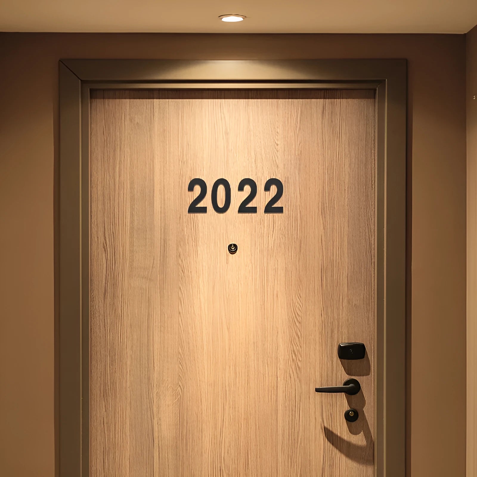 Black stainless steel sticky house number measuring 7.5cm with adhesive backing for waterproof door signage.