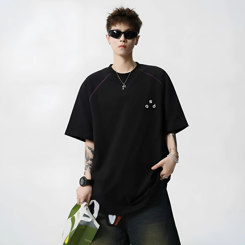 Black loose fit cotton T-shirt with short sleeves and a round neck collar featuring a letter print