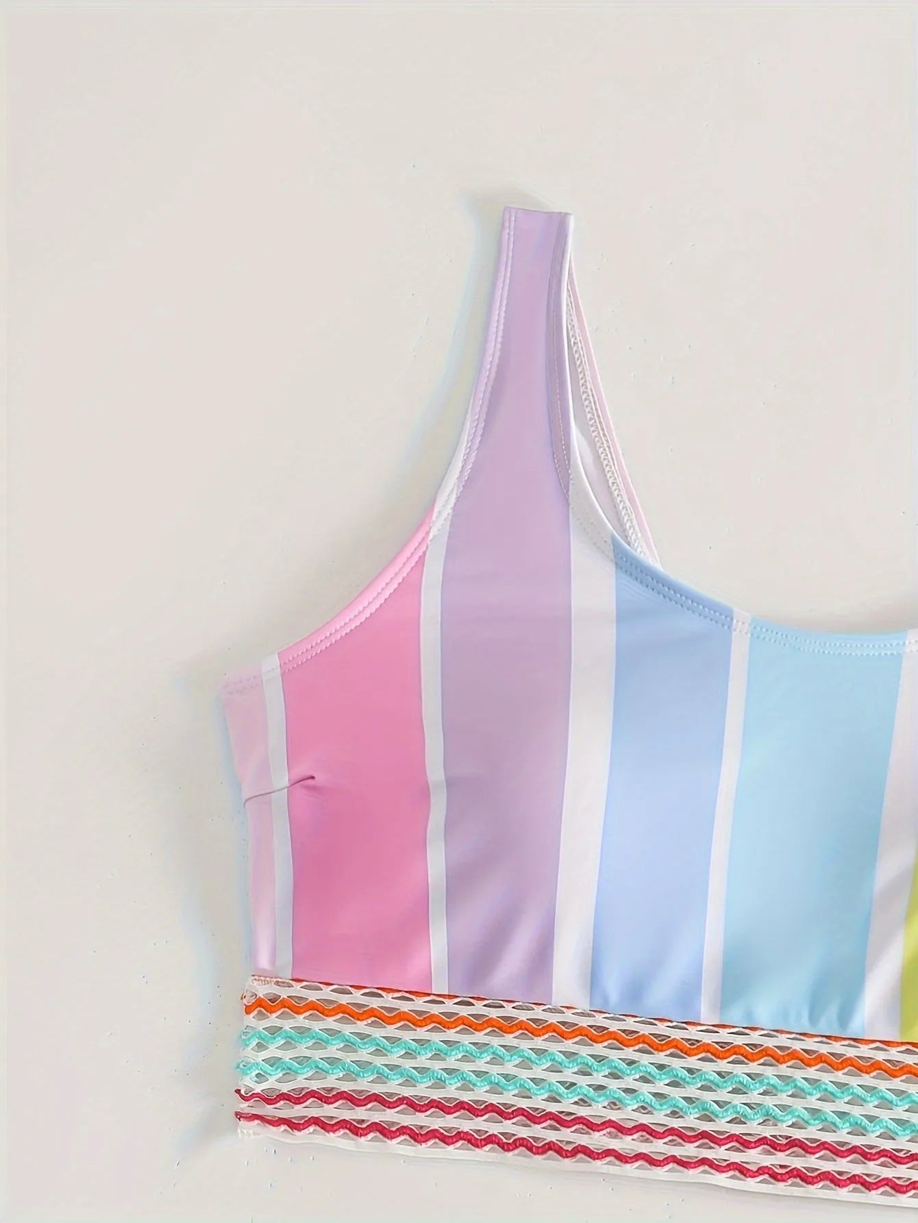 Women's striped sports bikini top and briefs set on a white background