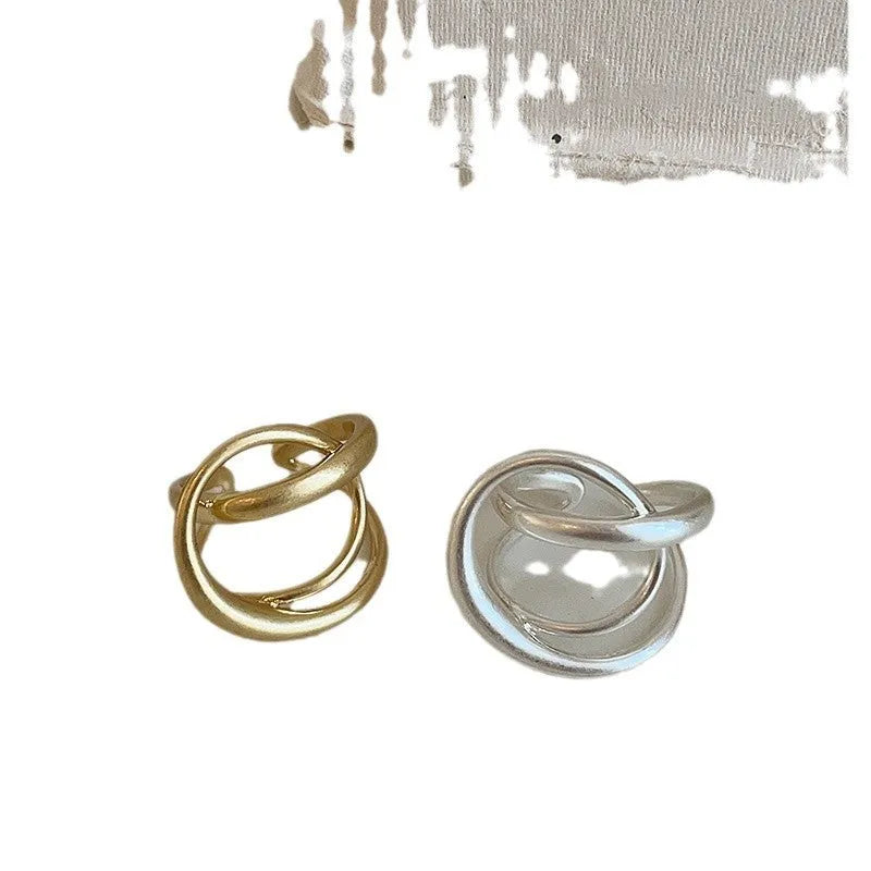 Gold and silver matte metal open rings with three-dimensional interlaced geometric design