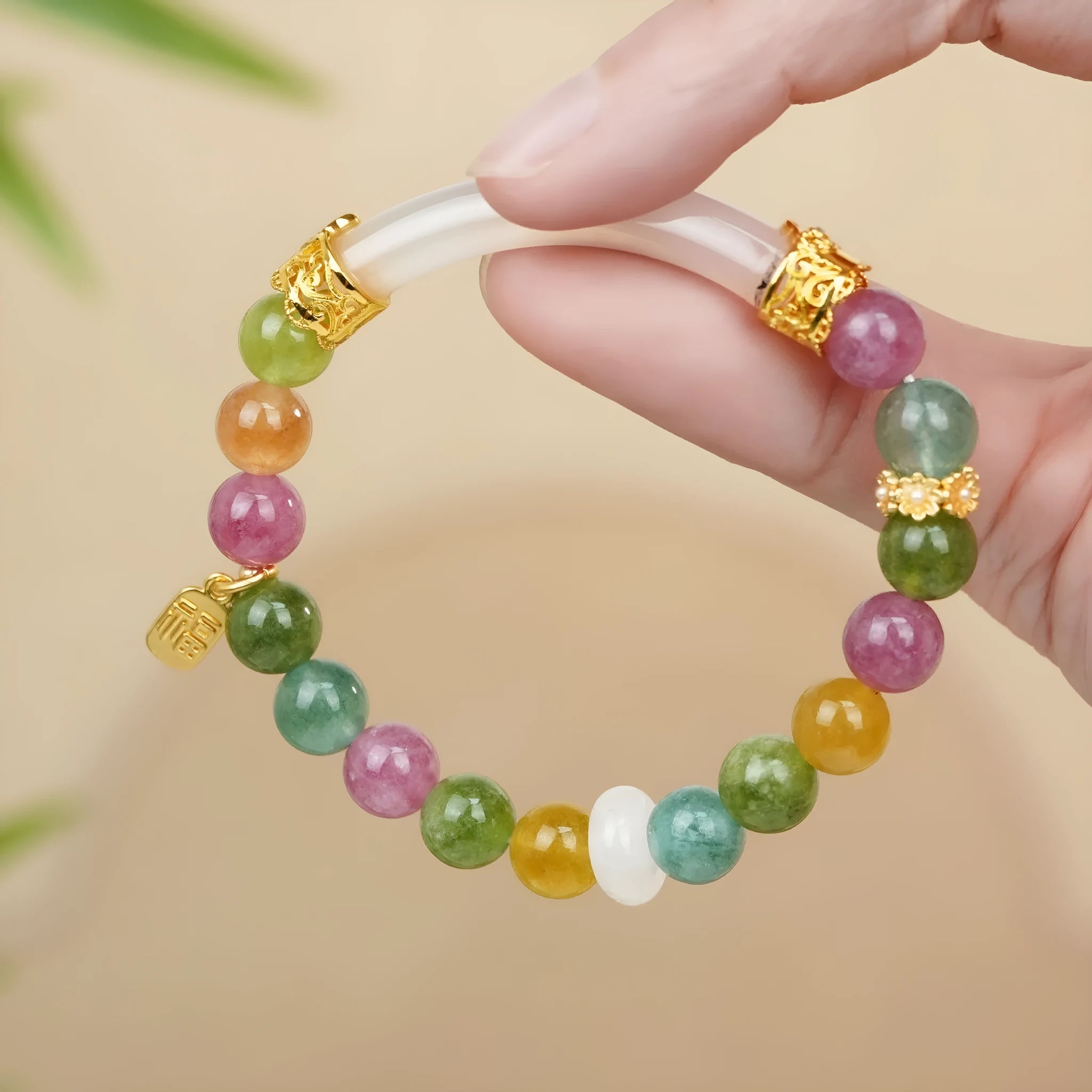 Rainbow tourmaline half-bracelet for women with natural jade colours and electroplated metal setting.