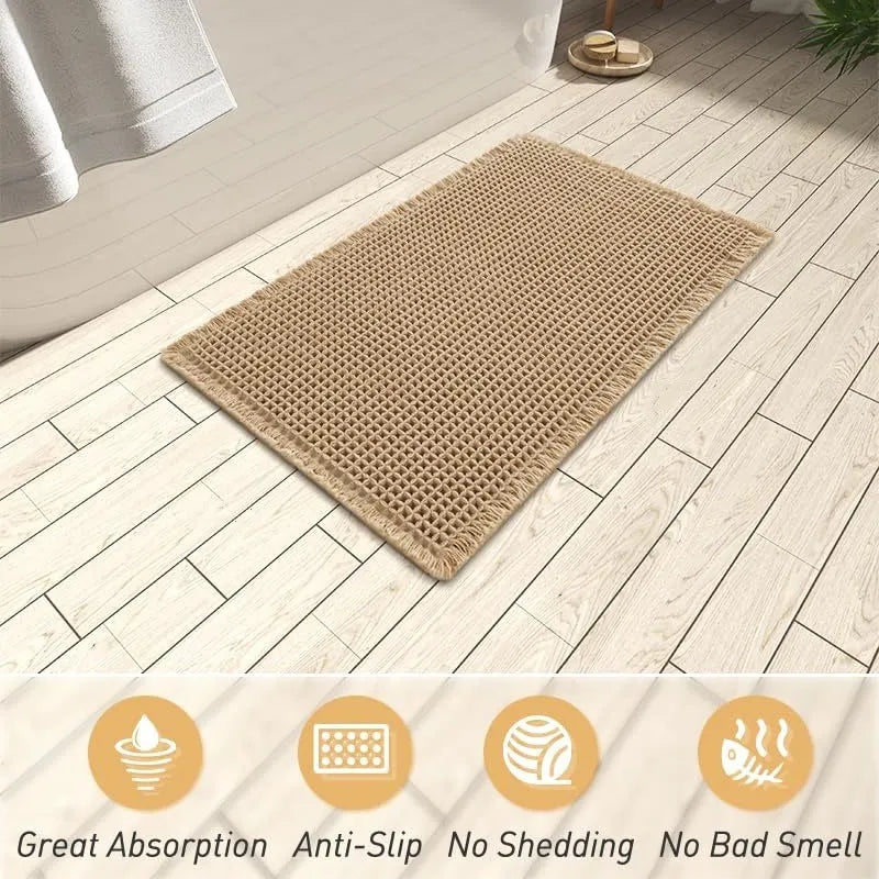 Beige and white checkered woven polyester bathroom floor mat on tiles.
