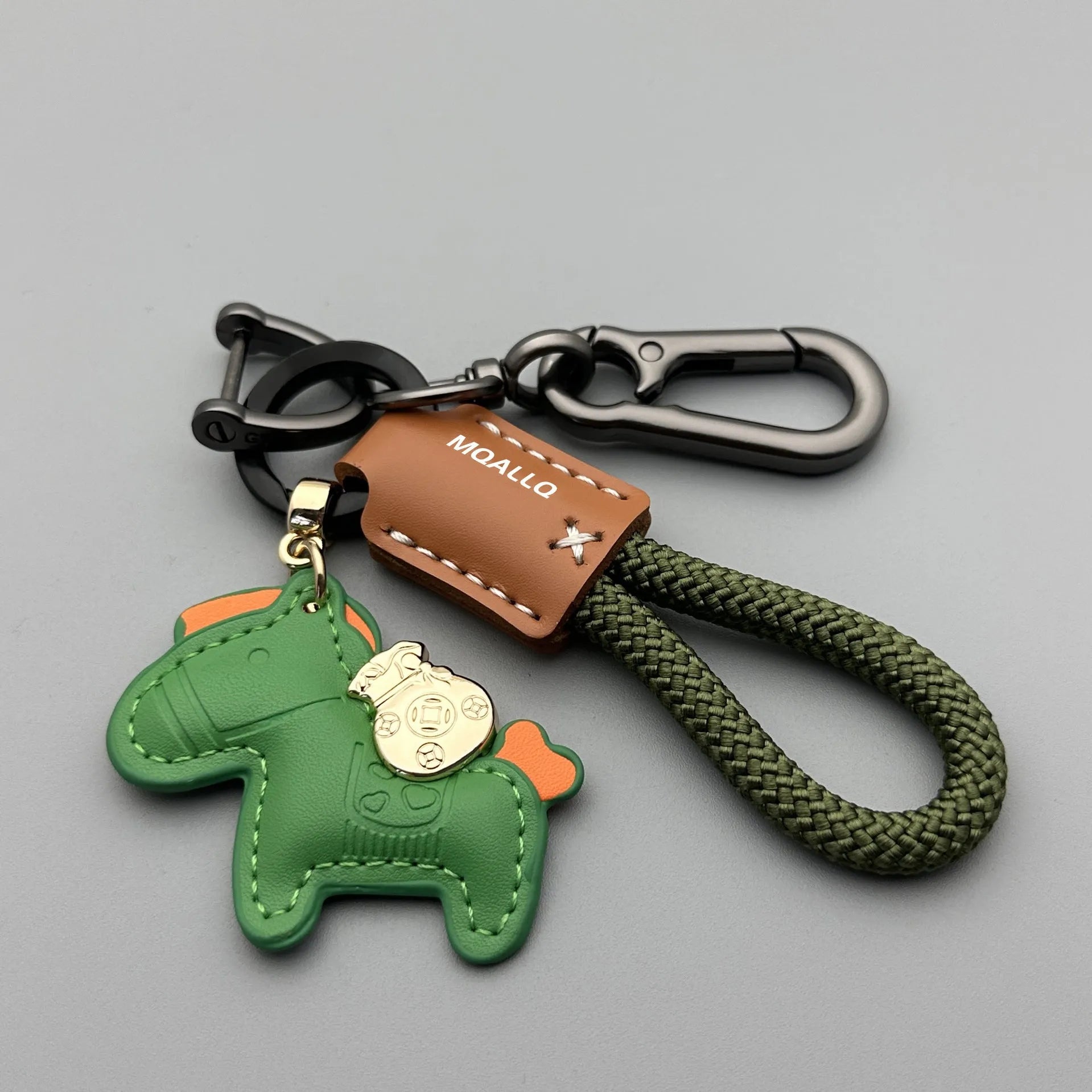 Handmade cowhide car keychain pendant with a zinc alloy pony buckle and coloured flanelle rope strap.