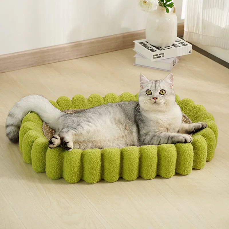 Green oval-shaped cat scratcher pad made of sisal, functioning as both a scratching surface and a lounge bed for cats.