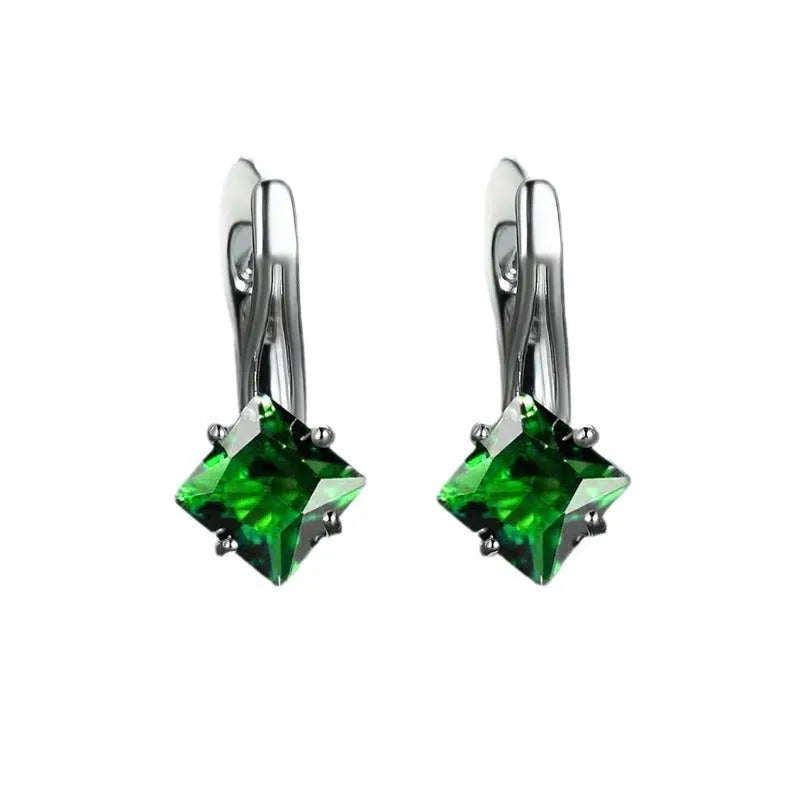 A pair of copper diamond design earrings for women with inlaid zircon stones, shown in blue, green, and a metallic colour.