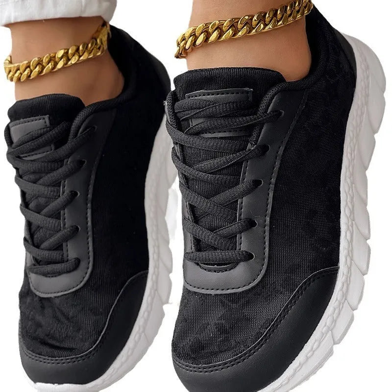 Women's canvas running shoes in white, black, blue, and pink colours with flat-heel construction