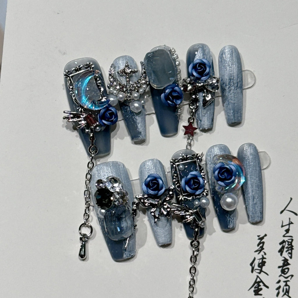 Heavy industry night blue false nails with ornate twinkling rose and tulip flower pattern.