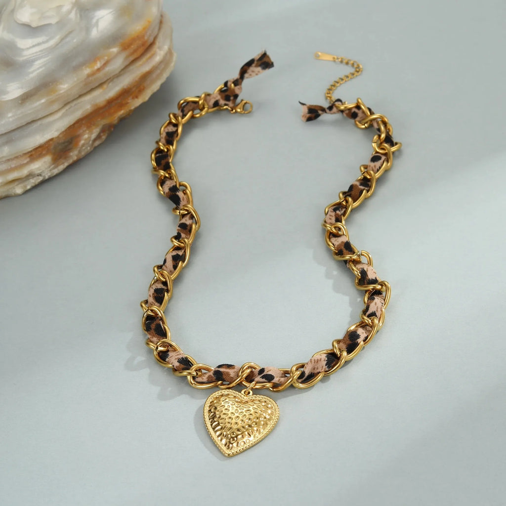 Leopard Love stainless steel necklace with geometric heart or sun pendant on a gold plated adjustable chain.
