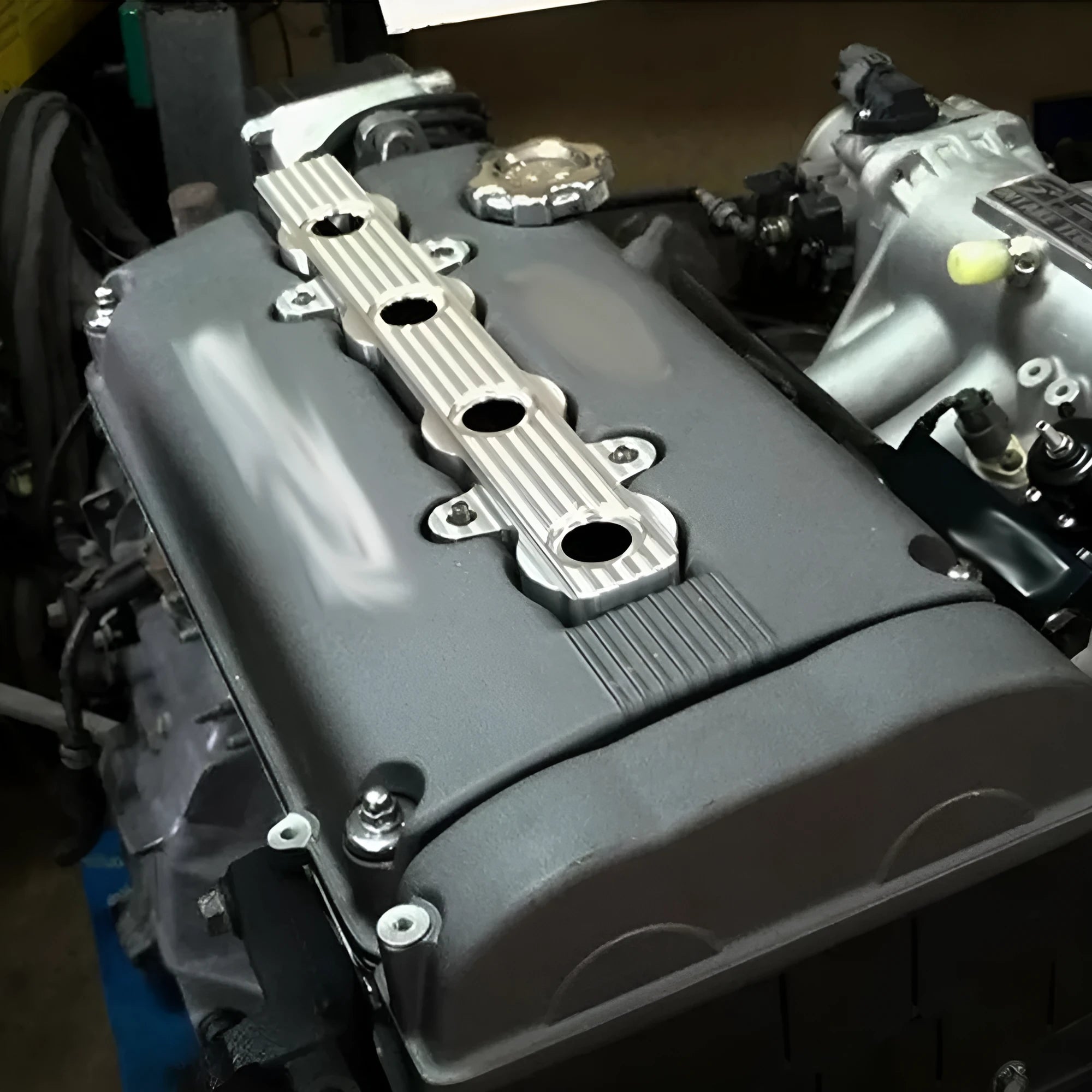 Aluminium alloy engine harness housing cover in blue, red, and silver, shown with and without mounting holes.