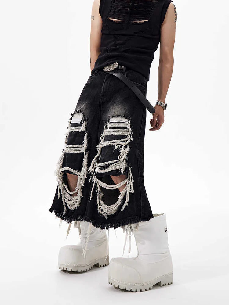 Black loose fit wide leg cropped jeans with a mid-high waist on a model.