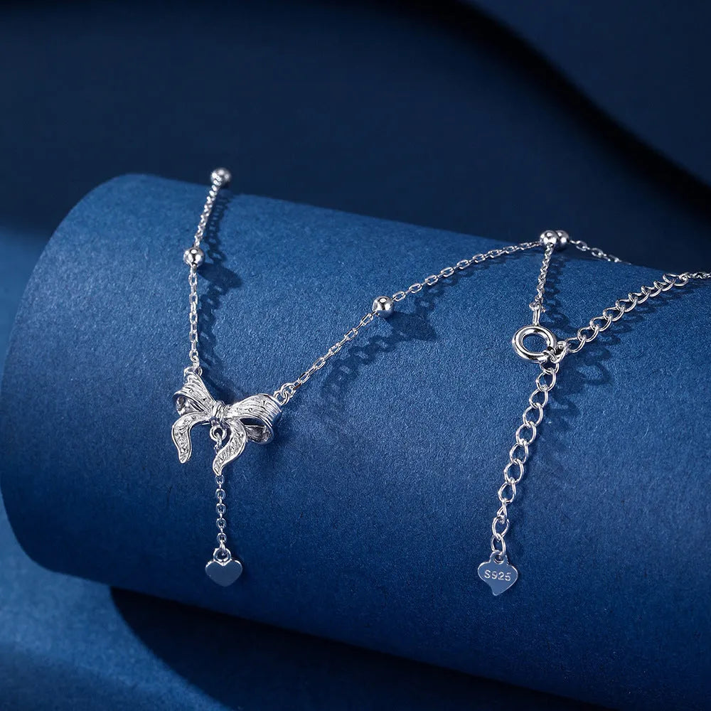 S925 sterling silver adjustable clavicle chain with a heart and butterfly pendant.