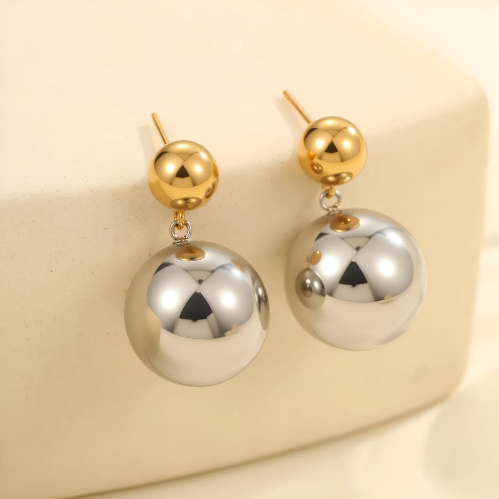 Stainless steel geometric ear studs with round beads and colour-block electroplated finish.