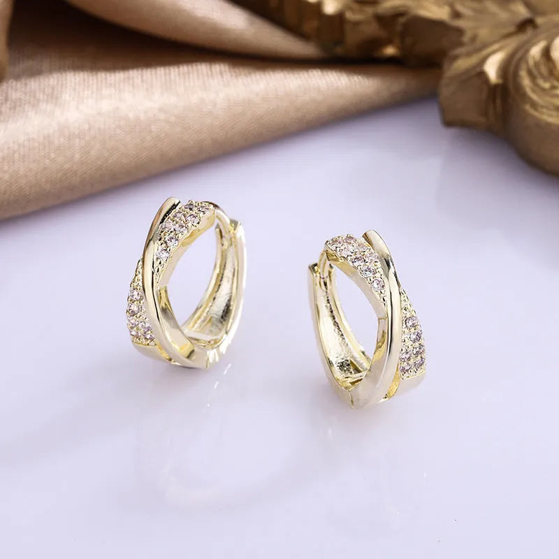 Geometric 14K yellow gold-plated earrings with zircon detailing on white background