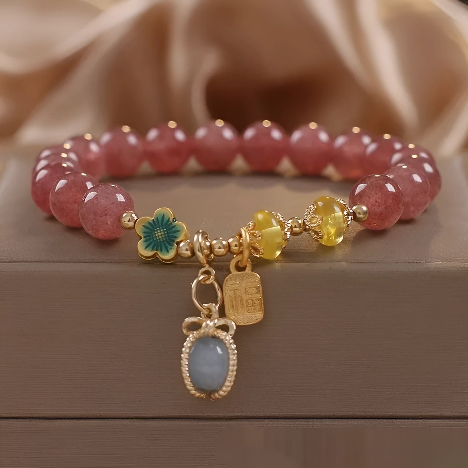 Red women's beaded bracelet with natural strawberry quartz stones, alloy metal, and rhinestone details.