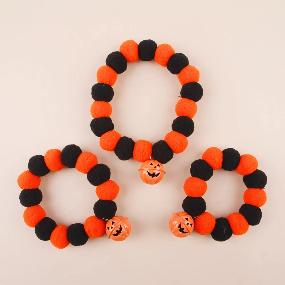 Orange and black pumpkin-themed adjustable cat collar for Halloween costumes.