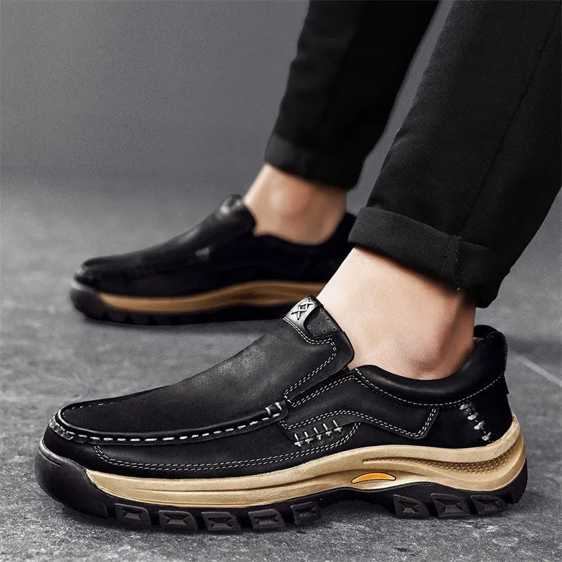 Men's black leather mountaineering shoes with thick rubber soles and round toe.