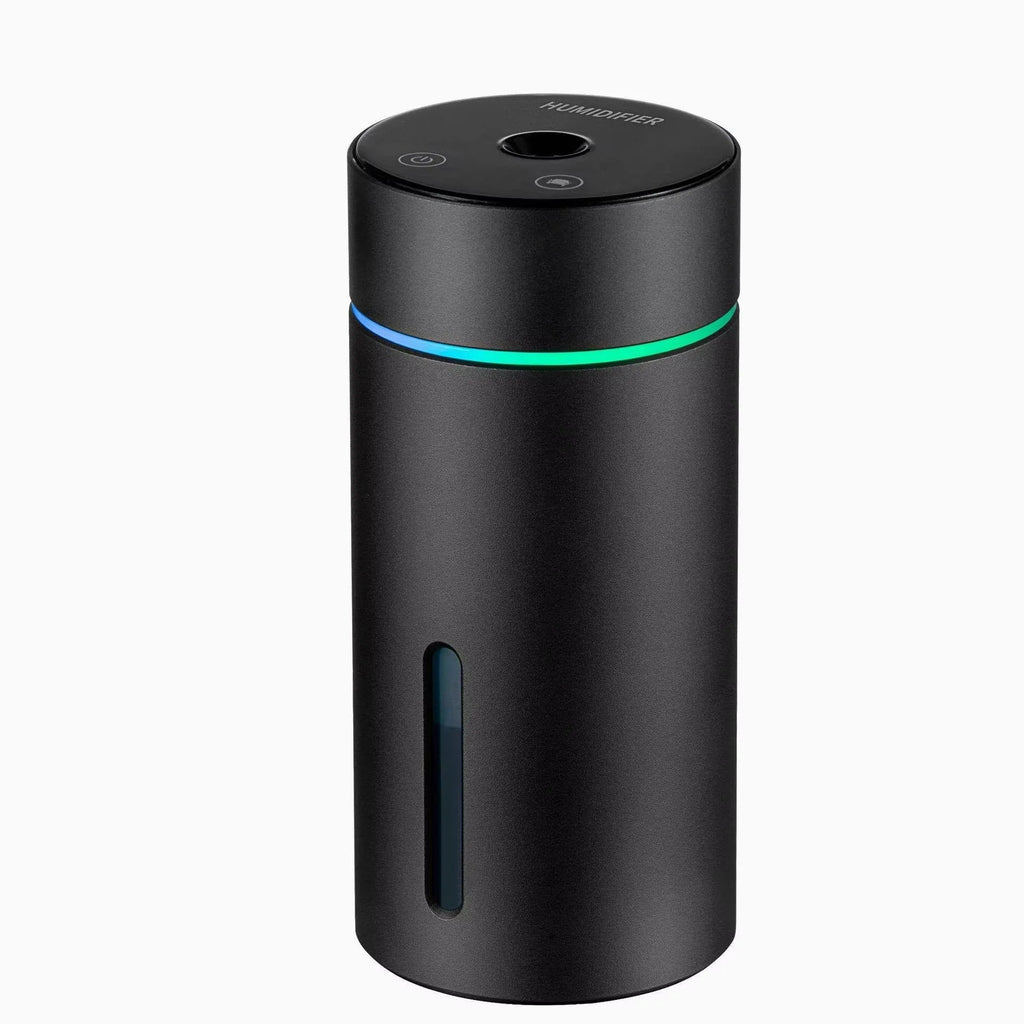 Black aluminium car humidifier diffuser with night light on a desk next to USB cable