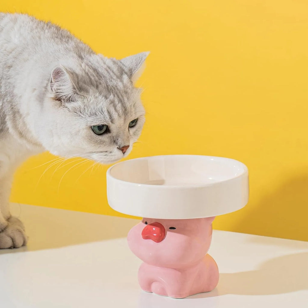 Raised ceramic cat bowl with animal theme design in pink, yellow, or white.