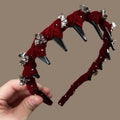 Women's non-slip velvet hairband with crystal wave detail in wine red colour.