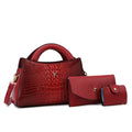 Women's black crocodile pattern crossbody handbag showing internal mobile phone and document compartments