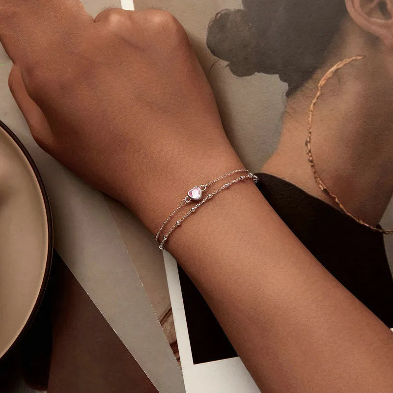 Women's sweet style sterling silver bracelet with a small heart-shaped charm on an adjustable chain.