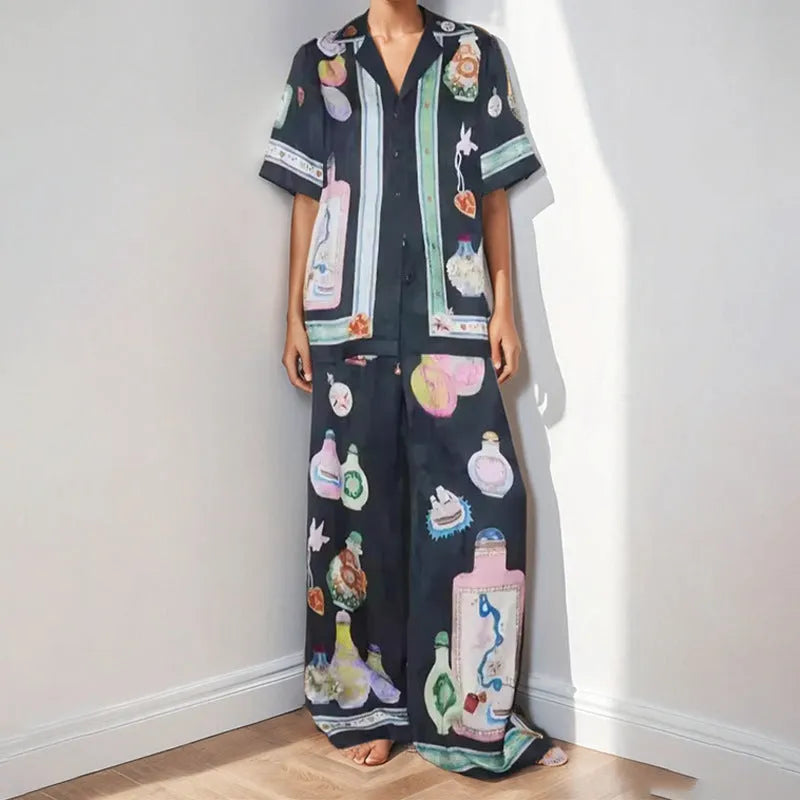 Black women's cardigan and trousers co-ord set with a cartoon pattern print.