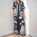 Black women's cardigan and trousers co-ord set with a cartoon pattern print.