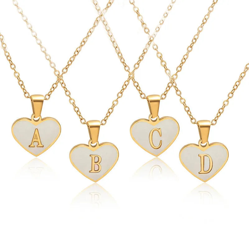 Gold-plated heart necklace with white shell centre on an adjustable stainless steel chain.