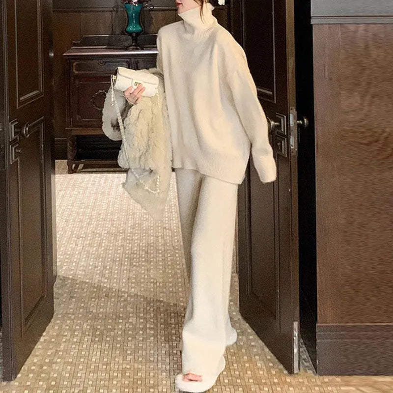 Women's beige casual sweater and wide-leg pants two-piece set on a hanger.