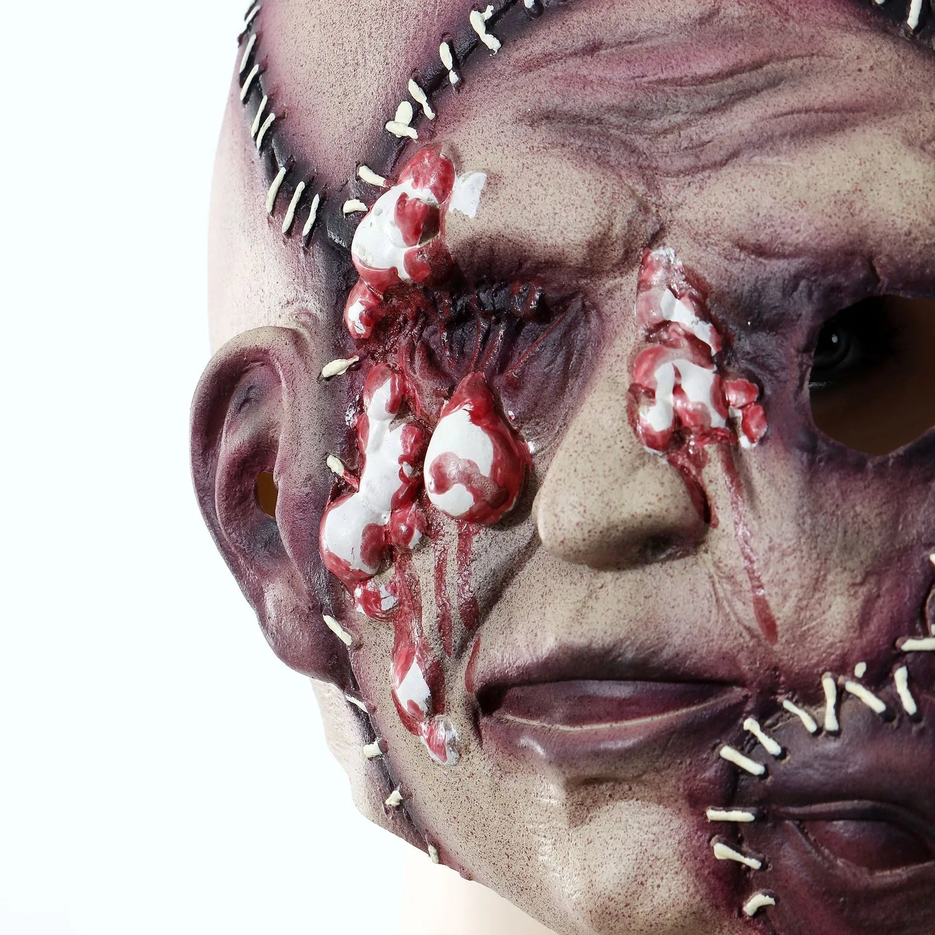 Three-sided grimace horror Halloween mask showing detailed latex texture and facial expression