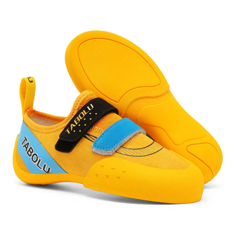 A pair of Velcro closure rock climbing shoes with a non-slip rubber sole in a black and red colour scheme.