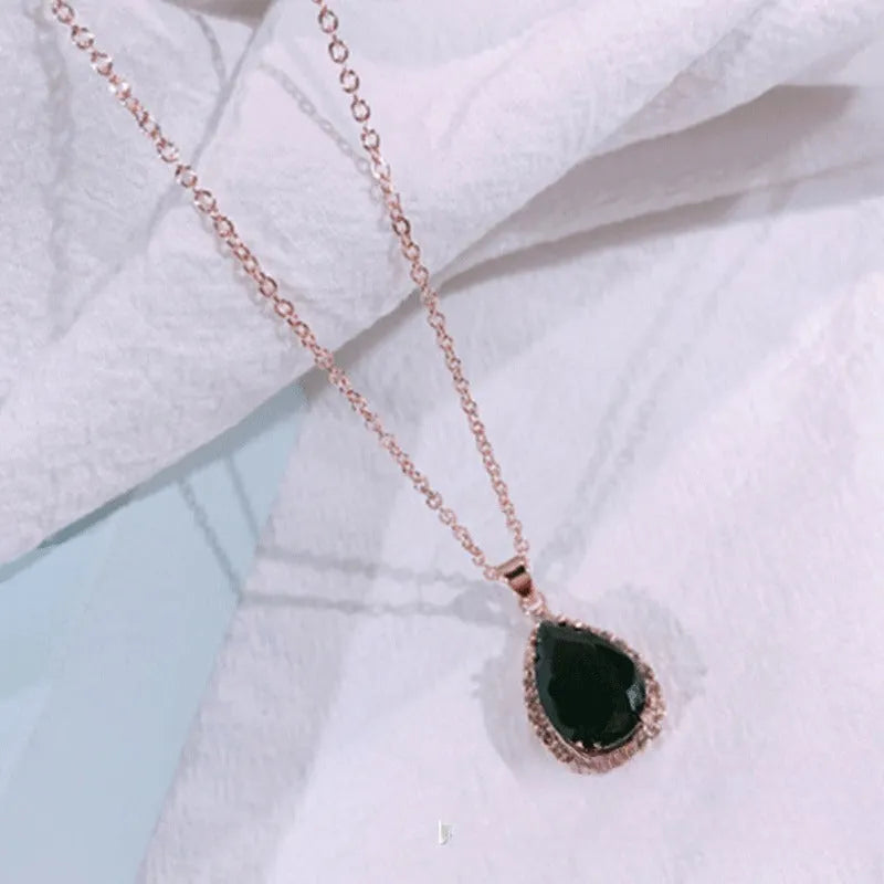 Pink drop shape women's necklace with geometric pendant design and rhinestone details