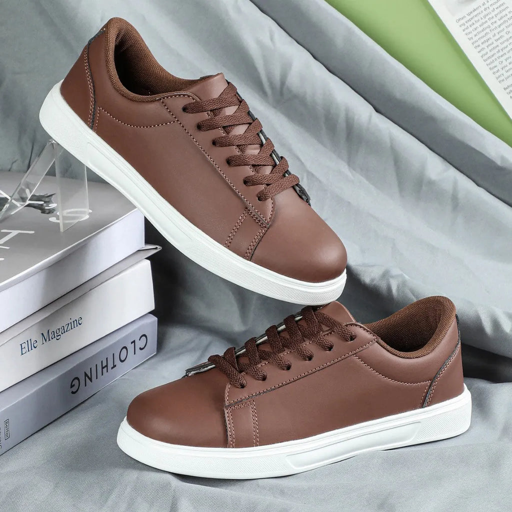 Beige brown casual platform sneakers with cross strap detail and rubber sole.