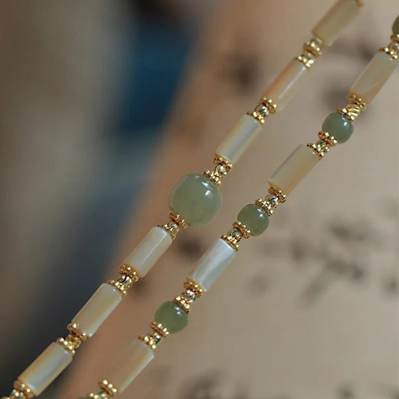 Handmade Hetian jade white lip shell bracelet with round beads on wrist
