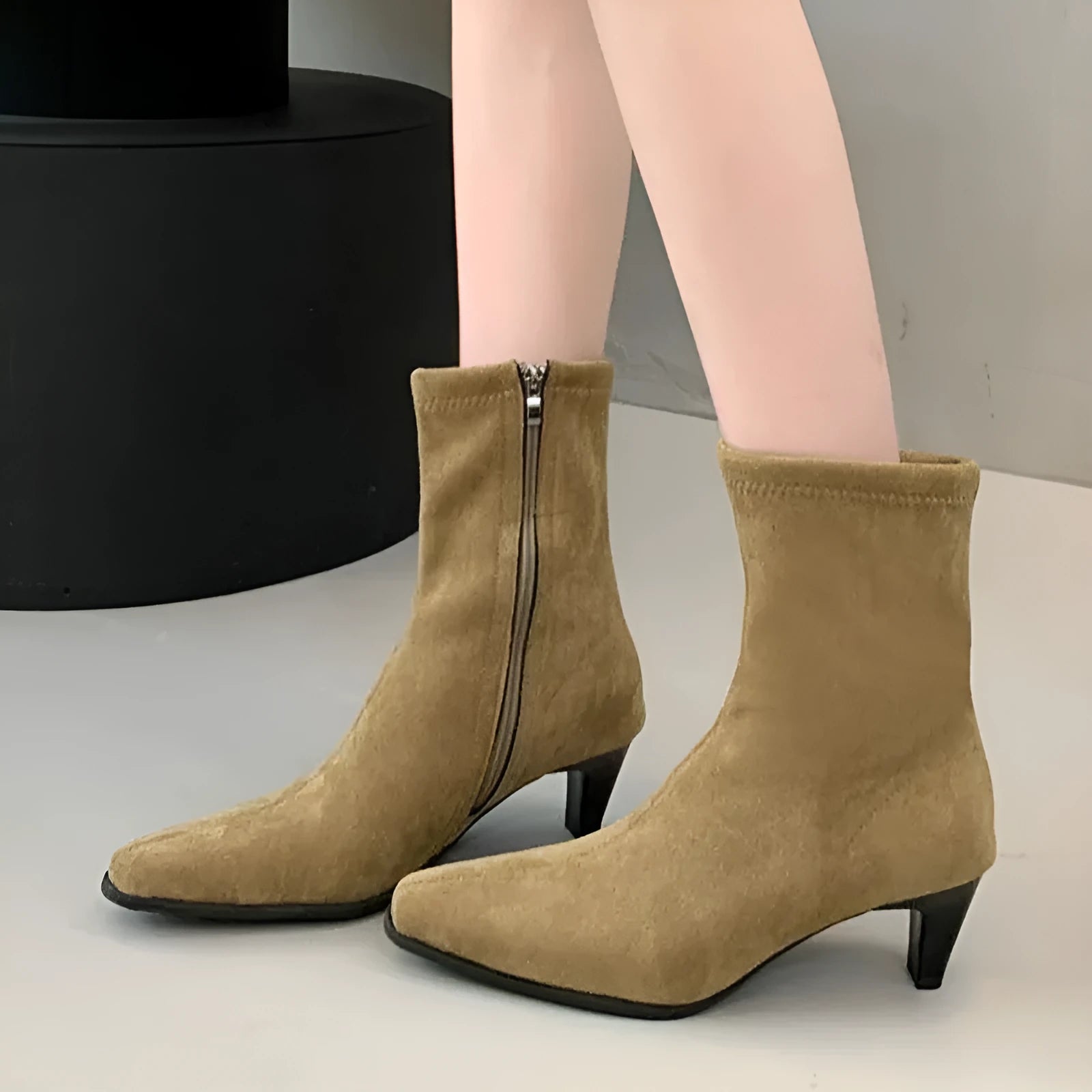 Brown square toe mid heel boots with side zip on a white background.