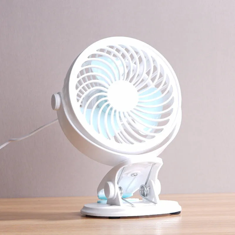 Small USB desk fan with clip attachment and floor stand options in white plastic housing